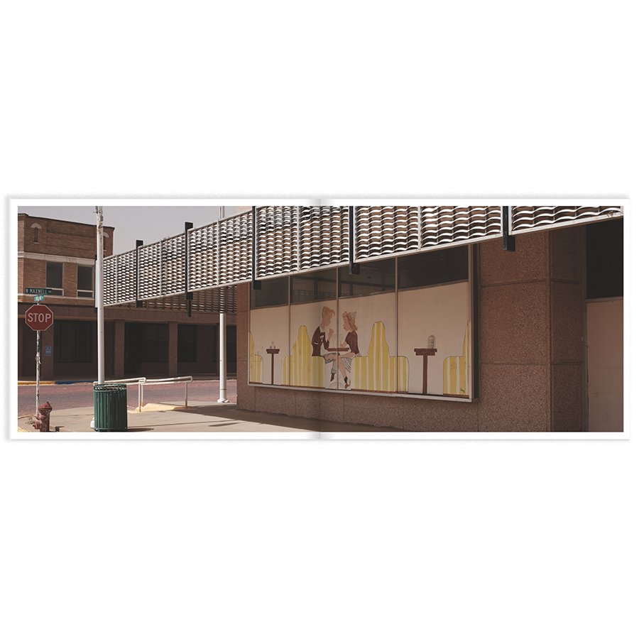 photo of a retro vintage mural in downtown Tulia, Texas. Yellow and maroon scene of two people at a diner table.